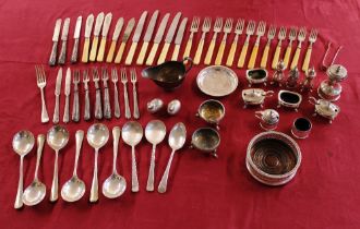 A collection of various plated cruet items, a plated coaster; various cutlery etc.