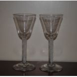 Two antique drinking glasses, having tapering bowls, spiral twist stems and circular spread feet