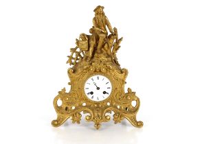 A 19th Century French gilt mantel clock, the case surmounted by a seated figure, circular white