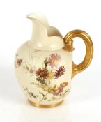 A Royal Worcester baluster jug, having floral spray decoration on an ivory ground, gilded handle and