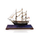 A model of a three masted sailing vessel, contained in case, 72.5cm long overall x 58cm high