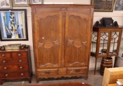 A large oak French armoire, with interior shelf and hanging compartment, two long drawers below