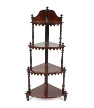 A Victorian rosewood graduated corner whatnot, raised on spiral turned columns, 124cm high