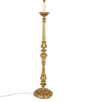 A large gilt standard lamp, having foliate and reeded decoration to the baluster column, red