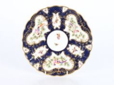 A Royal Worcester cabinet plate, profusely decorated butterflies and birds on a blue scale ground