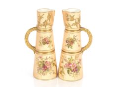 A pair of Royal Worcester jugs, of tapering form, having foliate spray decoration on blush ivory
