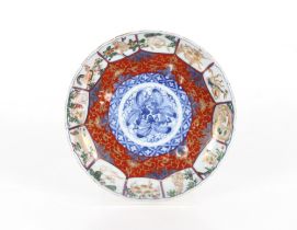 A pair of Imari scallop bordered dishes, decorated signs of the Zodiac around a central leaf