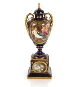 A late 19th Century Vienna porcelain vase on plinth, decorated with an oval panel of maidens and