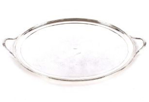 A large oval electroplated two handled tea tray, having reeded borders and loop handles, 67cm