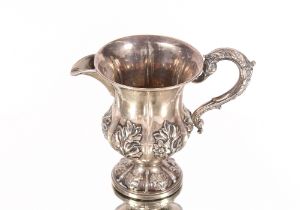 An Edwardian silver pedestal cream jug, Sheffield 1904, 4.5oz; a baluster cream jug with foliate