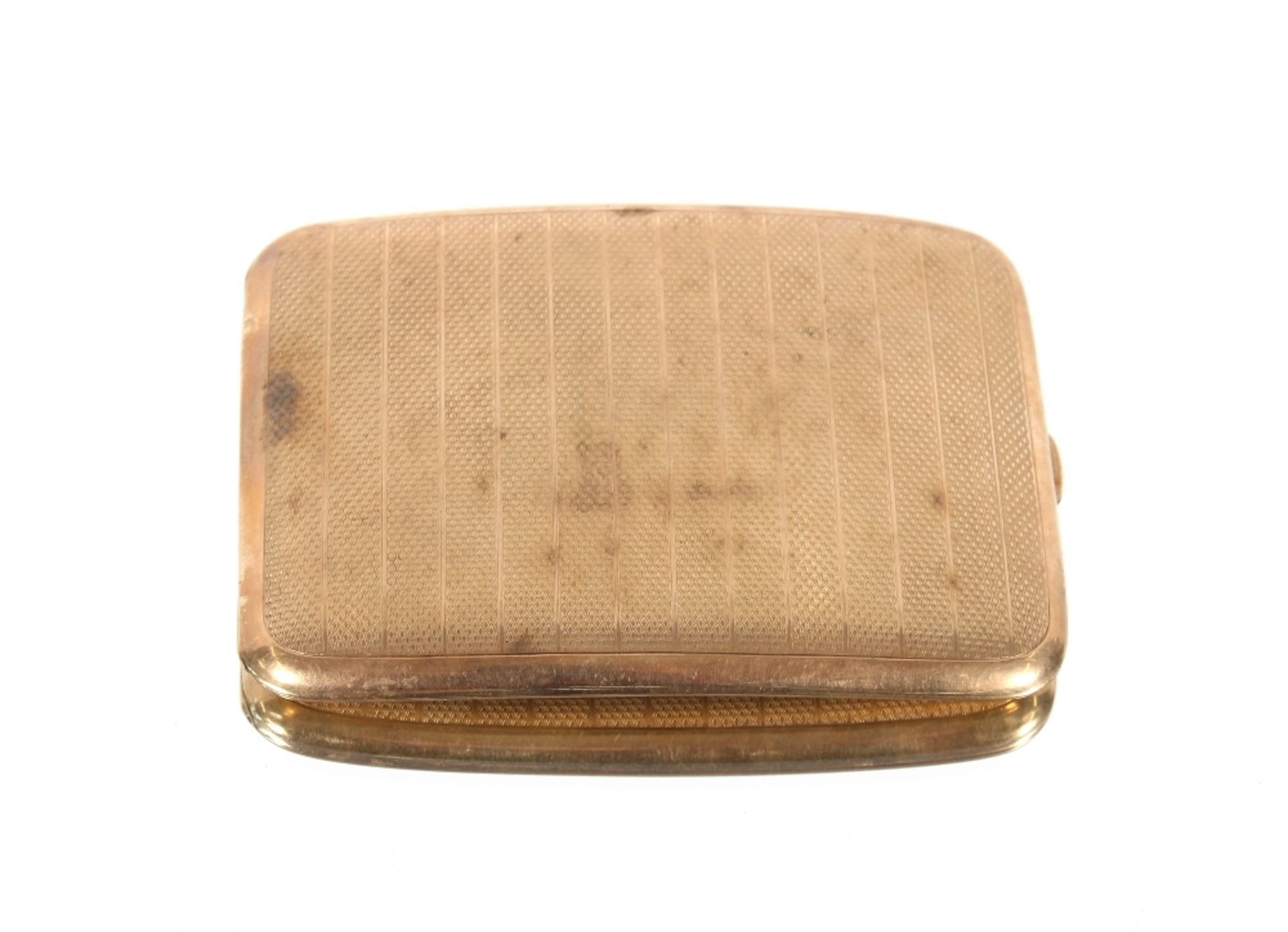 A George V 9ct gold cigarette case of curved form with engine turned decoration, Birmingham 1915,