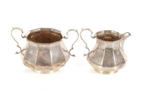 A silver cream jug and sucrier of baluster panelled form, Sheffield 1925, 14oz