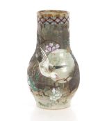 A Japanese pottery vase, decorated birds and foliage, 31cm high