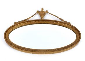 A pair of Edwardian oval gilt framed bevel edged wall mirrors, with urn and ribbon decoration,