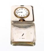 An eight day travelling clock, contained in silver hinged case, London 1915