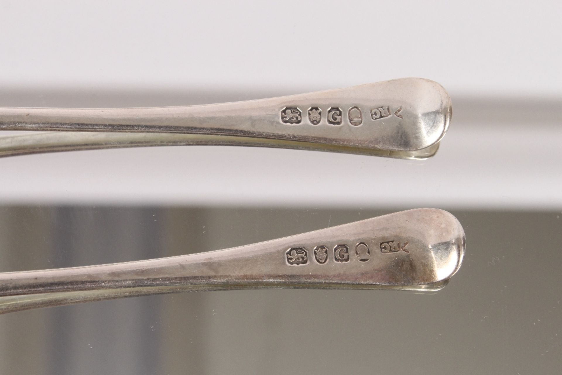 Nine George III silver "Old English" pattern dessert spoons, bearing family crests, London 1802; and - Image 7 of 8