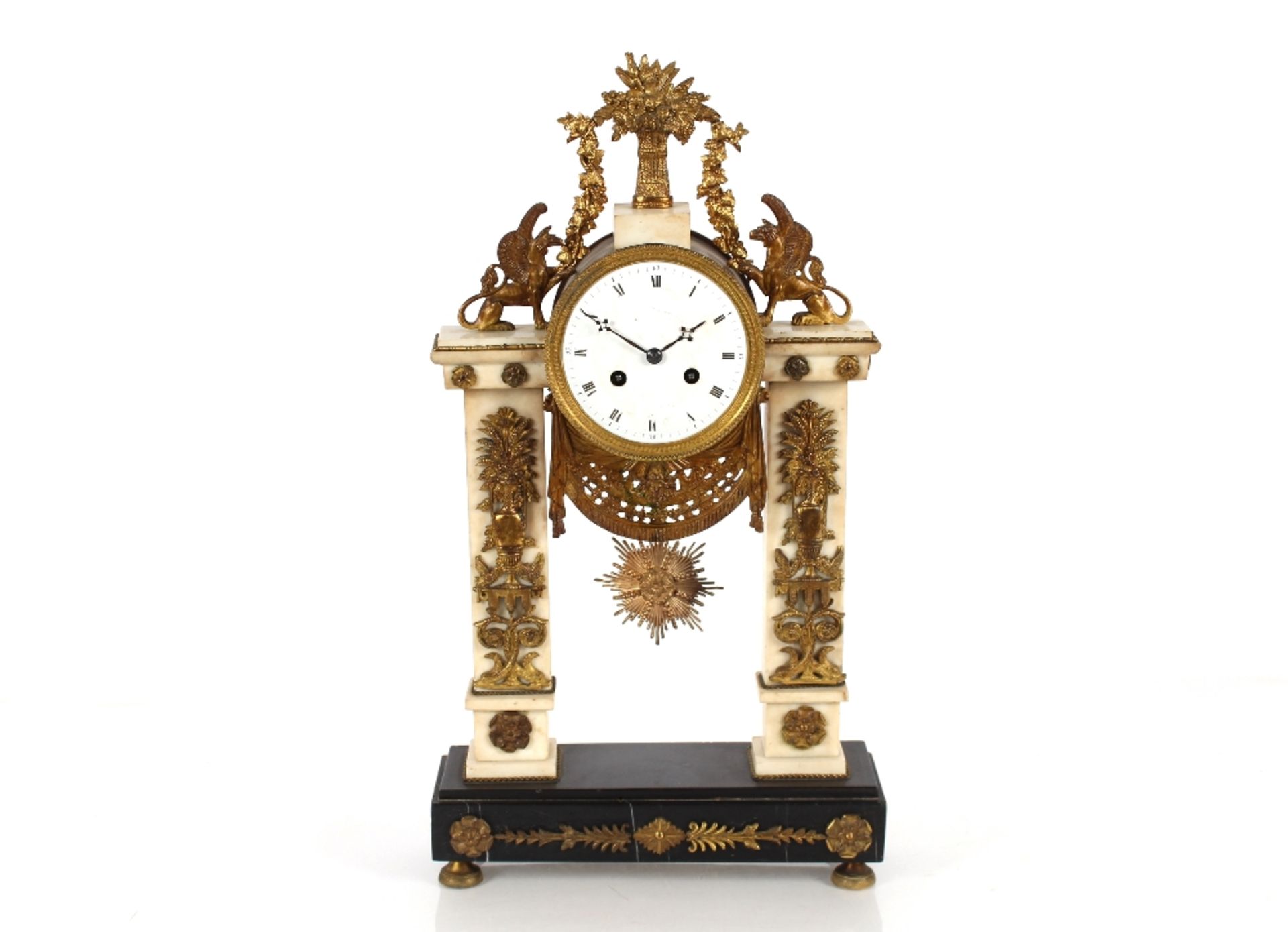 A 19th Century French marble and ormolu mounted mantel clock, surmounted by griffins and garlands,