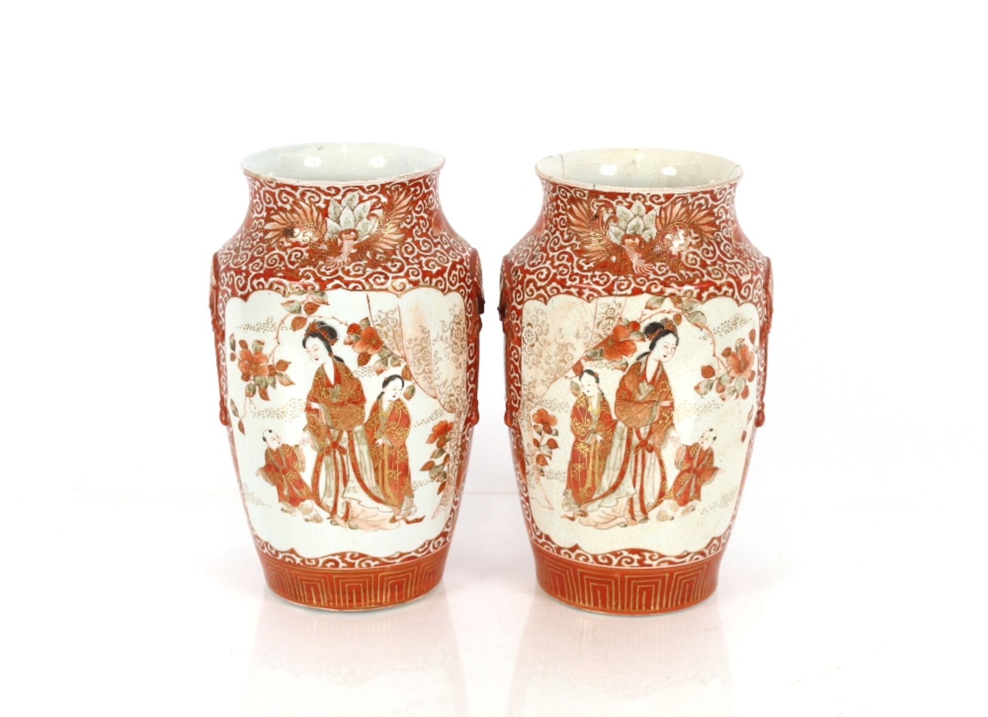 A pair of Japanese Kutani type baluster vases, decorated with figures in a garden setting, 28cm