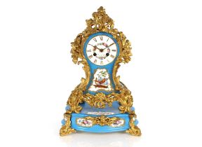 A Sevres style pale blue porcelain mantel clock on plinth, decorated foliate and bird panels with