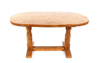 Workshop of Robert (Mouseman) Thompson of Kilburn, an oval English oak dining table with adzed