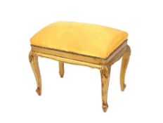 A gilt framed dressing stool, raised on cabriole supports, 54cm wide