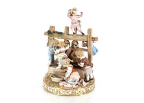 A 19th Century Meissen figure group, depicting children around a grape press, having encrusted