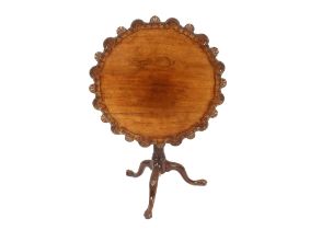 A 19th Century carved mahogany tripod table, the shaped shell decorated top raised on a birdcage and