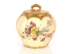 A Royal Worcester jar and cover of pumpkin shape, having foliate spray decoration on a blush ivory