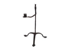 An 18th Century wrought iron tripod rush light and candle holder, 33cm high