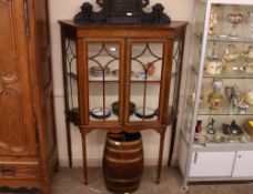An Edwardian inlaid mahogany china display cabinet of wedge shape, the silk lined interior