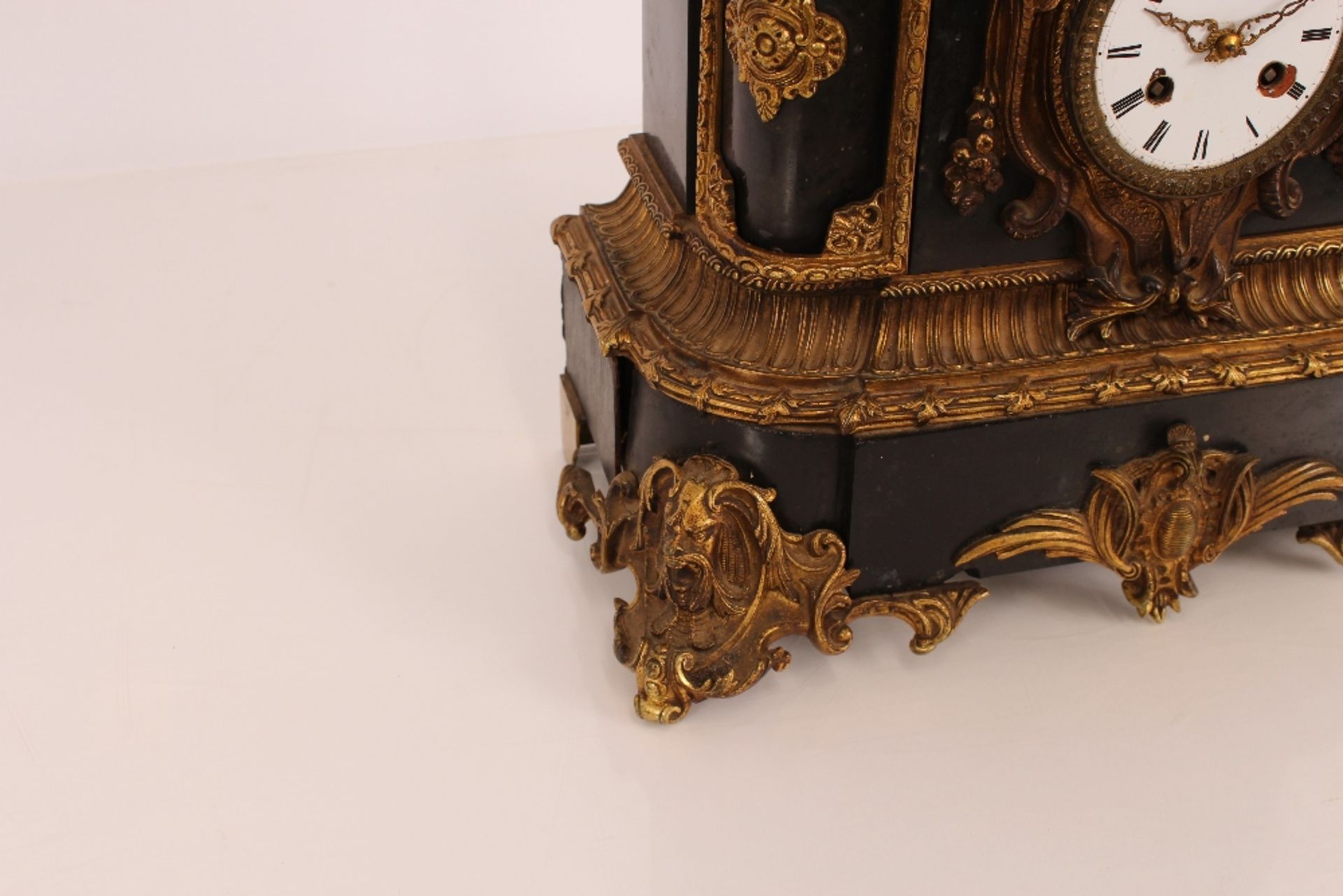 A 19th Century French black marble and Ormolu mounted mantel clock, surmounted by a seated bronze - Image 2 of 4