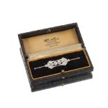A diamond brooch in white metal mount, set with two 0.25 carat diamonds surrounded with an
