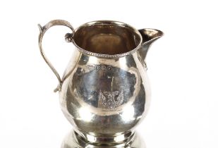 A small George V silver cream jug, of baluster form bearing double headed eagle crest, Birmingham