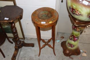 A small painted satin wood urn stand