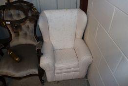 A child's wing back chair in Peony and Sage Rabbit