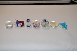 Seven glass paperweights to include Caithness and