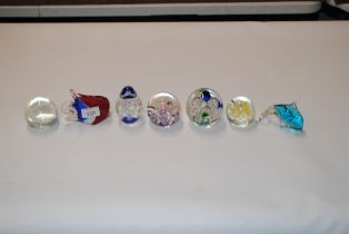 Seven glass paperweights to include Caithness and