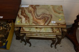 A nest of onyx and brass occasional tables