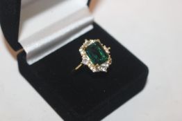 A 925 silver gilt ring set with emerald coloured a