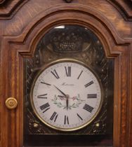 A carved oak long case clock with associated Frenc