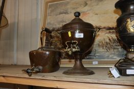 An antique copper samovar and a copper kettle with