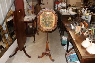 A Victorian rosewood pole screen, having floral de