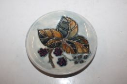 A Moorcroft Pottery circular dish with tube lined