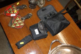 A pair of Bushnell binoculars; a pair of Halina bi