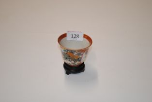 An Oriental cup with character mark to base raise