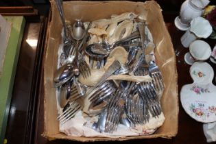 A box of various painted cutlery