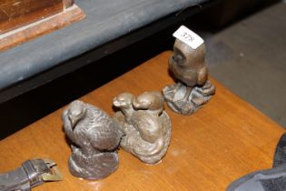 Three bronzed figures in the form of otters, owl a