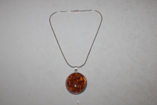 A large Hallmarked Sterling silver and amber penda