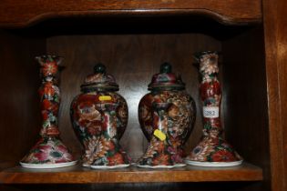 A pair of Imari pattern baluster vases and covers;