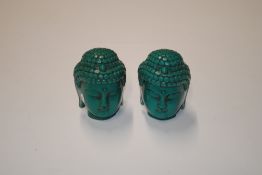 Two simulated turquoise Buddha heads